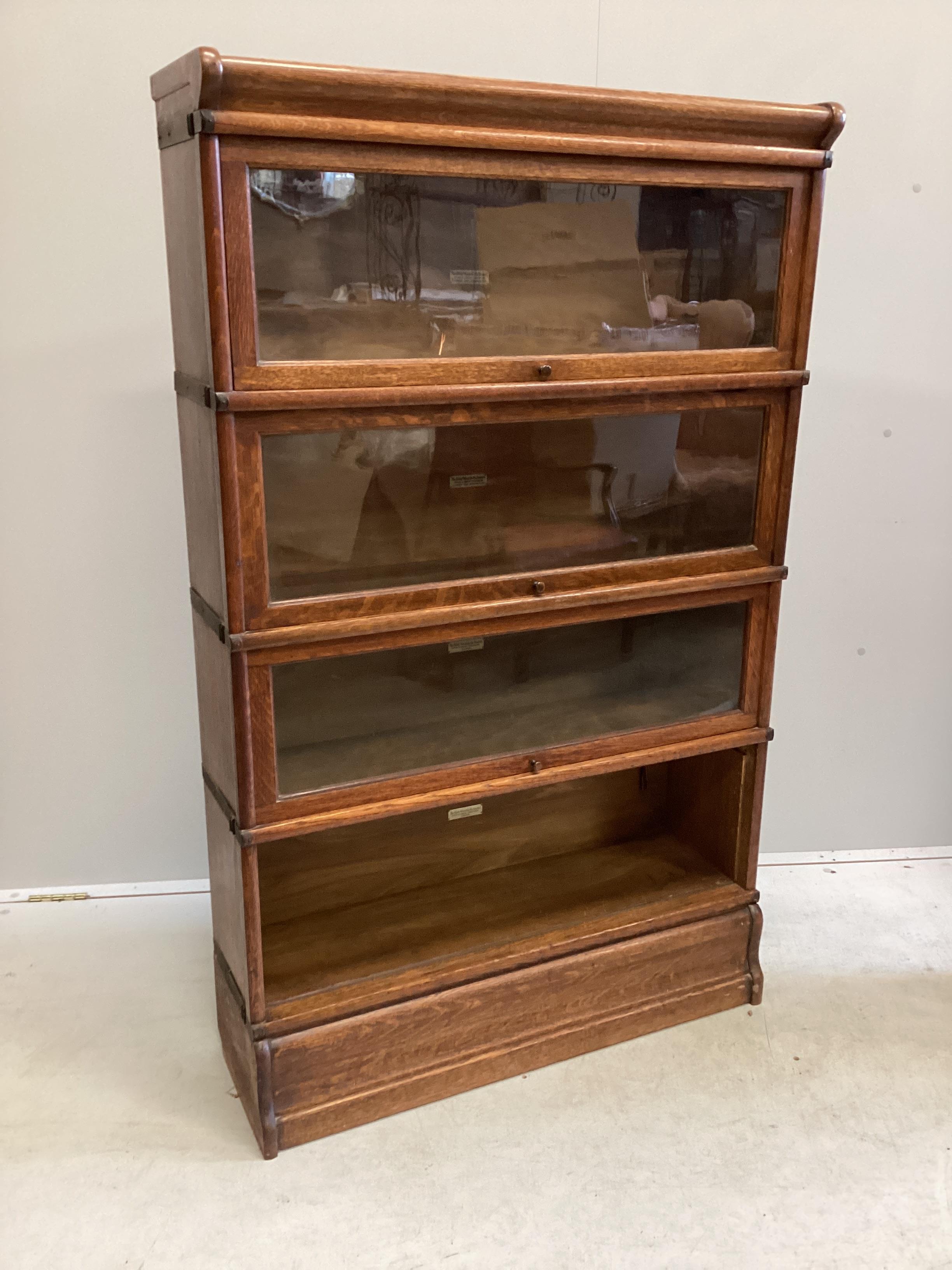 A Globe Wernicke oak four section bookcase, width 86cm, depth 27cm, height 140cm (one door detached)